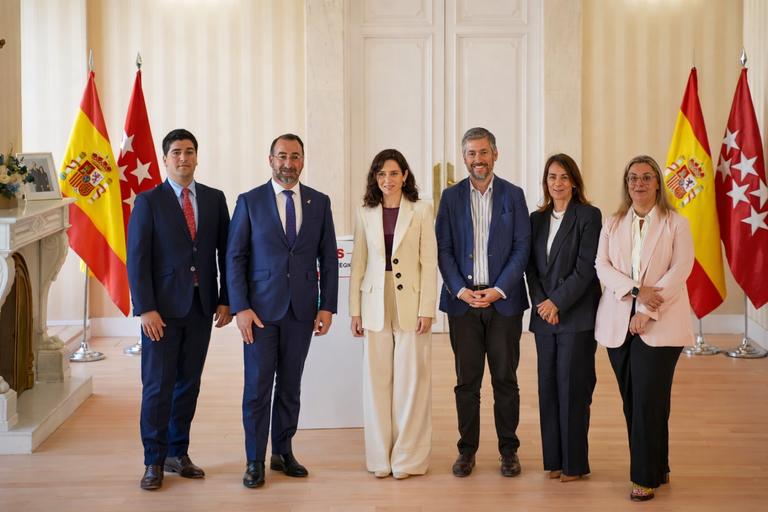 Foto grupal con banderas y podium.png